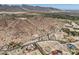 Aerial view featuring desert landscape, winding roads, and luxury homes surrounded by mountain scenery at 3284 W Highlands Dr, Buckeye, AZ 85396