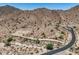 Desert homesite with paved road winding up to a custom luxury residence on the hillside at 3284 W Highlands Dr, Buckeye, AZ 85396