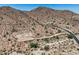 Desert homesite with paved road winding up to a custom luxury residence on the hillside at 3284 W Highlands Dr, Buckeye, AZ 85396