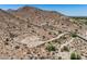 Desert homesite with paved road winding up to a custom luxury residence on the hillside at 3284 W Highlands Dr, Buckeye, AZ 85396