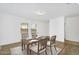 Dining area with a wood table, four chairs, and a window for natural light at 33731 N Bowles Dr, San Tan Valley, AZ 85144