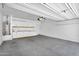 Spacious two car garage featuring painted walls, concrete floor and built in shelving at 33731 N Bowles Dr, San Tan Valley, AZ 85144