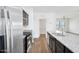 Open kitchen with granite countertops, stainless steel appliances, and hardwood floors at 33731 N Bowles Dr, San Tan Valley, AZ 85144