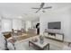 Bright, open-concept living space with hardwood floors, a ceiling fan, and modern furniture at 33731 N Bowles Dr, San Tan Valley, AZ 85144