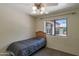 Bedroom featuring a ceiling fan, carpet, and a bright window at 350 E Huber St, Mesa, AZ 85201