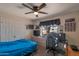 This bedroom features a ceiling fan, closet, desk, and a large window at 350 E Huber St, Mesa, AZ 85201
