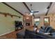 Cozy living room with brick fireplace, beamed ceilings, and lots of natural light at 350 E Huber St, Mesa, AZ 85201
