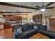 Open-concept living room with beamed ceilings, fireplace, and connected kitchen at 350 E Huber St, Mesa, AZ 85201