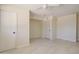 Bedroom featuring two doors, a ceiling fan, and tile floors at 35019 N Central Ave, Phoenix, AZ 85086