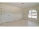 Light filled bedroom features neutral walls, door to left, and arched window at 35019 N Central Ave, Phoenix, AZ 85086