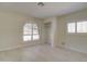 Bright bedroom with tile floors and arched windows with plantation shutters at 35019 N Central Ave, Phoenix, AZ 85086