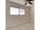 This bedroom features a large window overlooking a tranquil outdoor view at 35019 N Central Ave, Phoenix, AZ 85086