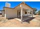 Exterior view of the backyard facade with a covered patio area and French doors at 35019 N Central Ave, Phoenix, AZ 85086