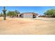 Property featuring a stucco home, a spacious driveway, and a detached garage or shed on a desert landscape at 35019 N Central Ave, Phoenix, AZ 85086