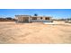 View of home's rear with open patio, desert landscaping, and detached garage, ready for outdoor living at 35019 N Central Ave, Phoenix, AZ 85086
