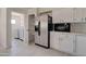 Updated kitchen with stainless fridge and view into laundry room at 35019 N Central Ave, Phoenix, AZ 85086