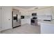 Updated kitchen features stainless appliances, breakfast bar, and white cabinets at 35019 N Central Ave, Phoenix, AZ 85086