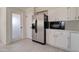 Kitchen boasts stainless steel refrigerator, white cabinets, and tile floors at 35019 N Central Ave, Phoenix, AZ 85086