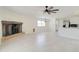Spacious living area with tile floors, ceiling fan, and fireplace feature at 35019 N Central Ave, Phoenix, AZ 85086