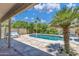 Lush backyard with a covered patio, a swing, and mature landscaping surrounding the sparkling pool, creating a serene retreat at 3580 W Dublin St, Chandler, AZ 85226