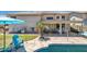 Outdoor living area with a covered patio, grill, and seating next to a pool and lush green lawn at 3580 W Dublin St, Chandler, AZ 85226