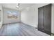 A bedroom with vinyl floors, a ceiling fan, and a view of the neighborhood at 3580 W Dublin St, Chandler, AZ 85226