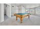 A large game room with neutral colors, carpet flooring and a pool table as a focal point at 3580 W Dublin St, Chandler, AZ 85226