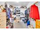 Messy walk-in closet featuring shelving and hanging storage at 3580 W Dublin St, Chandler, AZ 85226