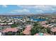An aerial view of a lakeside community featuring houses, palm trees, and scenic mountain views at 3830 E Lakewood E Pkwy # 2126, Phoenix, AZ 85048