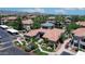 Aerial view of condos showing landscaping, views of the community clubhouse, and parking areas at 3830 E Lakewood E Pkwy # 2126, Phoenix, AZ 85048