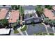 Aerial view of a landscaped entrance of condos with red tile roofs, green trees and a gate at 3830 E Lakewood E Pkwy # 2126, Phoenix, AZ 85048