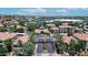 Aerial view of condos with red tile roofs and lush landscaping and a community building in the center at 3830 E Lakewood E Pkwy # 2126, Phoenix, AZ 85048