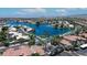 Scenic aerial view of community by lake with palm trees, tile roofs, and mountain backdrop at 3830 E Lakewood E Pkwy # 2126, Phoenix, AZ 85048