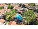 Aerial view of community pool with nearby condos and lush tropical landscaping at 3830 E Lakewood E Pkwy # 2126, Phoenix, AZ 85048