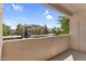 Enjoy scenic balcony views of building and mature trees under clear blue skies, creating a peaceful outdoor retreat at 3830 E Lakewood E Pkwy # 2126, Phoenix, AZ 85048
