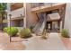 Exterior view of building showcasing a walkway and stairs to upper units and desert landscaping at 3830 E Lakewood E Pkwy # 2126, Phoenix, AZ 85048