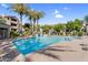 Spacious community pool surrounded by palm trees, providing a refreshing oasis for residents to enjoy at 3830 E Lakewood E Pkwy # 2126, Phoenix, AZ 85048