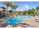 Sparkling community pool with lounge chairs and lush landscaping surrounding area at 3830 E Lakewood E Pkwy # 2126, Phoenix, AZ 85048