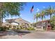 Welcoming entrance to the Portofino Condominiums with an American flag waving in a clear blue sky at 3830 E Lakewood E Pkwy # 2126, Phoenix, AZ 85048