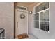 Charming front door with wreath and 'hello' doormat, complemented by a secure window with bars at 3830 E Lakewood E Pkwy # 2126, Phoenix, AZ 85048