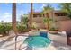 Inviting blue-tiled hot tub surrounded by lush landscaping and charming architecture in a well-maintained community at 3830 E Lakewood E Pkwy # 2126, Phoenix, AZ 85048