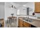 Cozy eat-in kitchen featuring wood cabinets, durable countertops, and views to the dining room at 3830 E Lakewood E Pkwy # 2126, Phoenix, AZ 85048