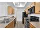 Bright kitchen featuring wood cabinets, black appliances, and ample counter space for meal preparation at 3830 E Lakewood E Pkwy # 2126, Phoenix, AZ 85048