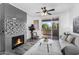 Inviting living room featuring a modern fireplace, balcony access, and ample natural light at 3830 E Lakewood E Pkwy # 2126, Phoenix, AZ 85048