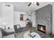 Bright open-concept living area featuring a modern fireplace and seamless transition to the dining area at 3830 E Lakewood E Pkwy # 2126, Phoenix, AZ 85048