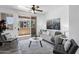 Cozy living room with sliding glass doors leading to a balcony with neighborhood views at 3830 E Lakewood E Pkwy # 2126, Phoenix, AZ 85048
