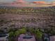 Expansive aerial view of desert landscape and neighborhood homes under a vivid sunset sky at 40123 N Majesty Trl, Anthem, AZ 85086