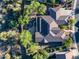 Aerial view of home with tile roof, solar panels, landscaped backyard and mature desert landscaping at 40123 N Majesty Trl, Anthem, AZ 85086