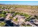 Expansive aerial view showcasing the home's landscaping, tile roof, and neighborhood amid desert terrain at 40123 N Majesty Trl, Anthem, AZ 85086