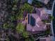 Aerial nighttime view of tile roof home, fire pit, patio, desert landscaping, and mature trees at 40123 N Majesty Trl, Anthem, AZ 85086